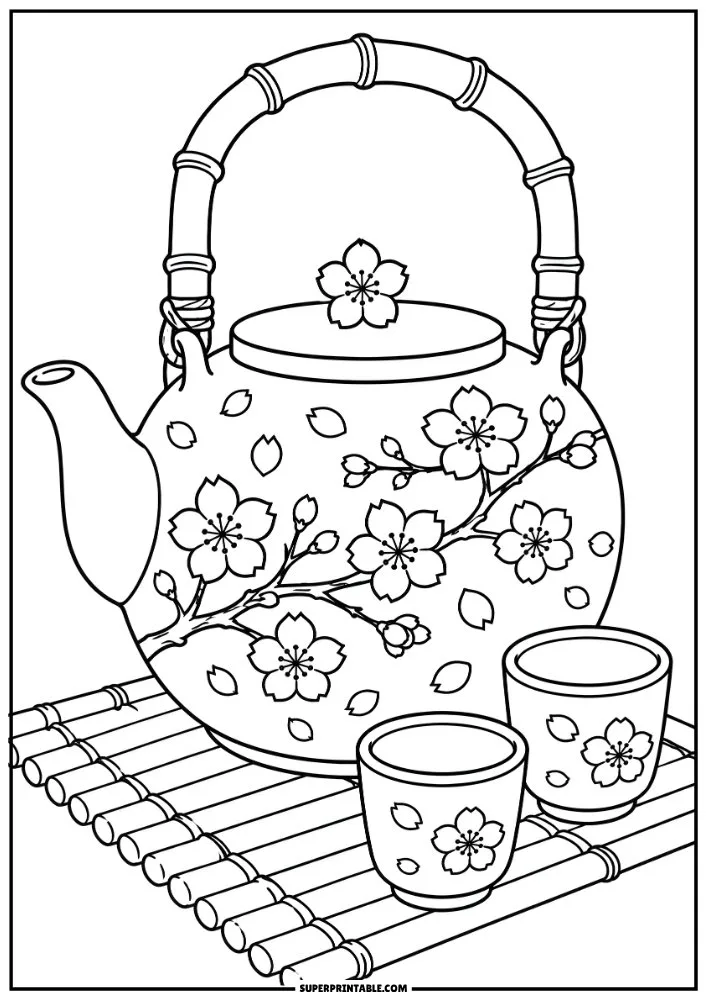 Cherry blossom teapot and tea cups on a bamboo mat with floral details.