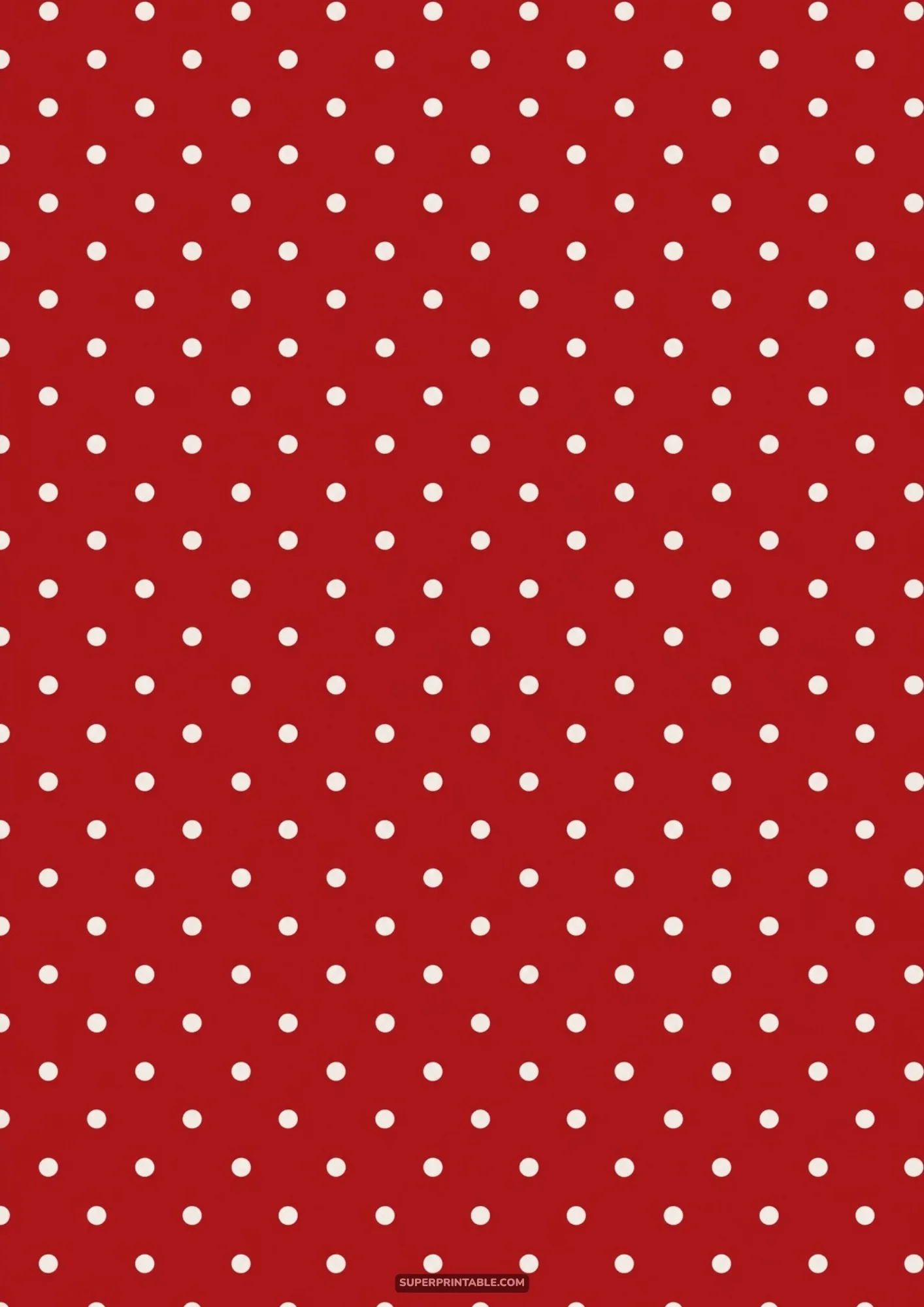 Small off-white polka dots evenly spaced over a rich cranberry red background sheet.
