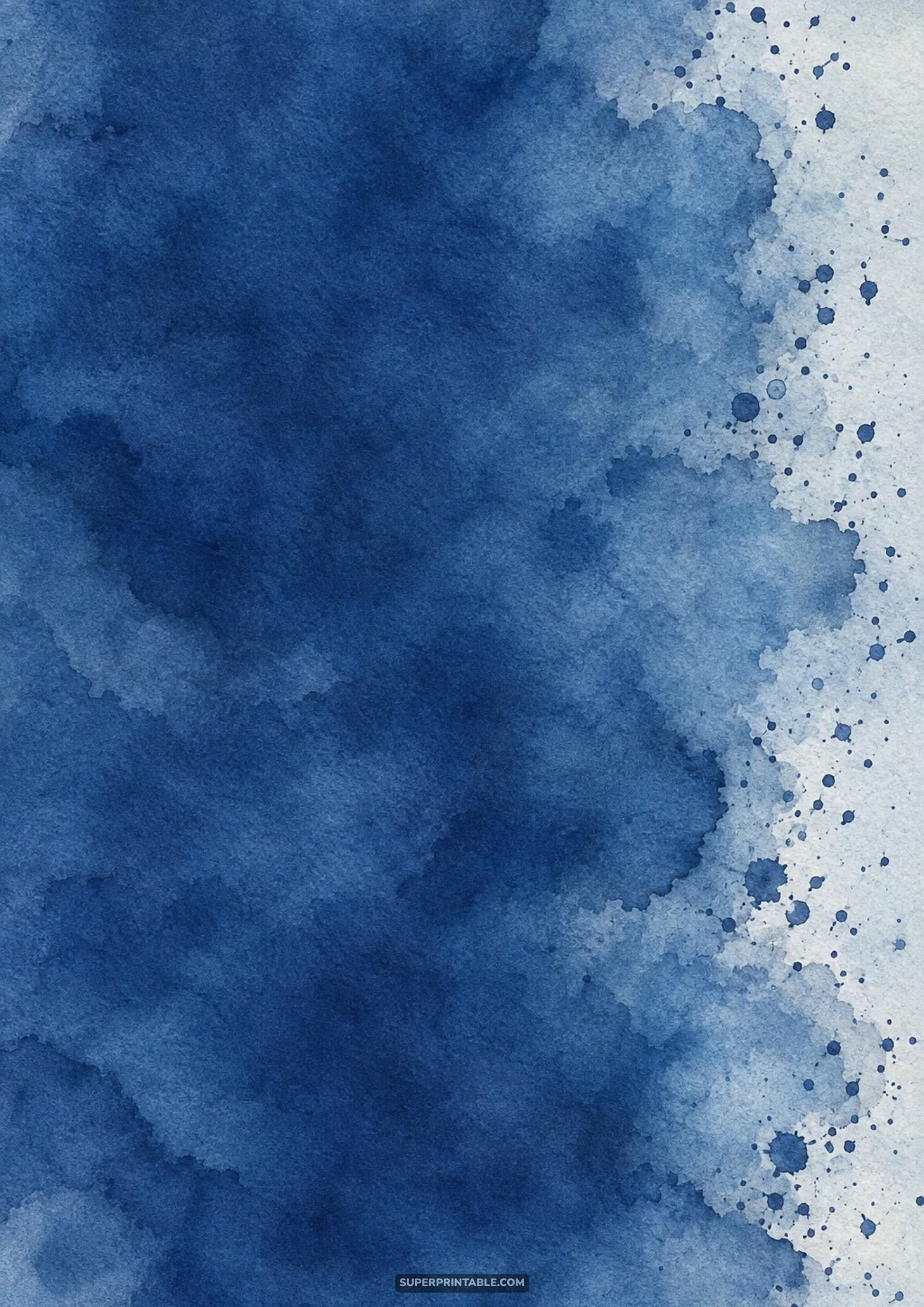 Deep indigo watercolor wash with organic feathered edge and scattered paint droplets.