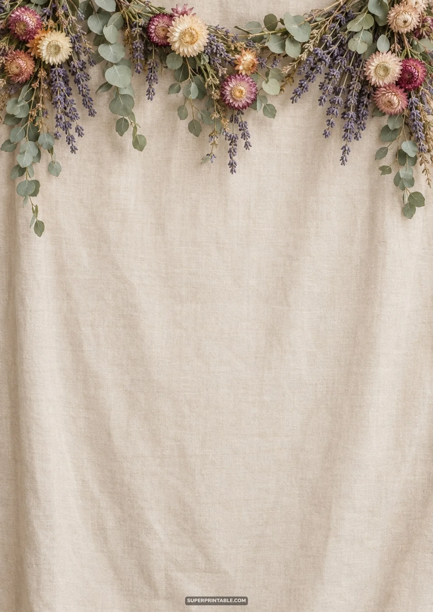 Curved garland of dried pink strawflowers, purple lavender, and eucalyptus on neutral linen