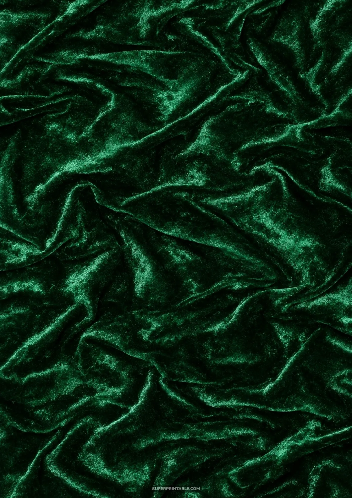 Deep emerald green crushed velvet fabric texture with luminous folds and rich shadowed ripples