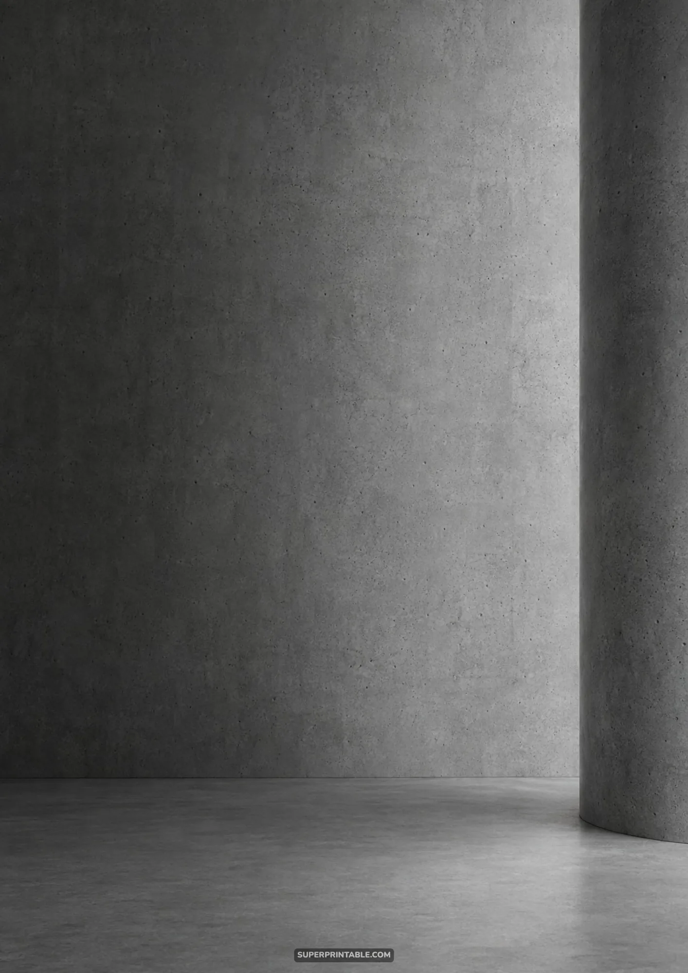 Brutalist studio interior featuring smooth concrete floor and massive cylindrical pillar