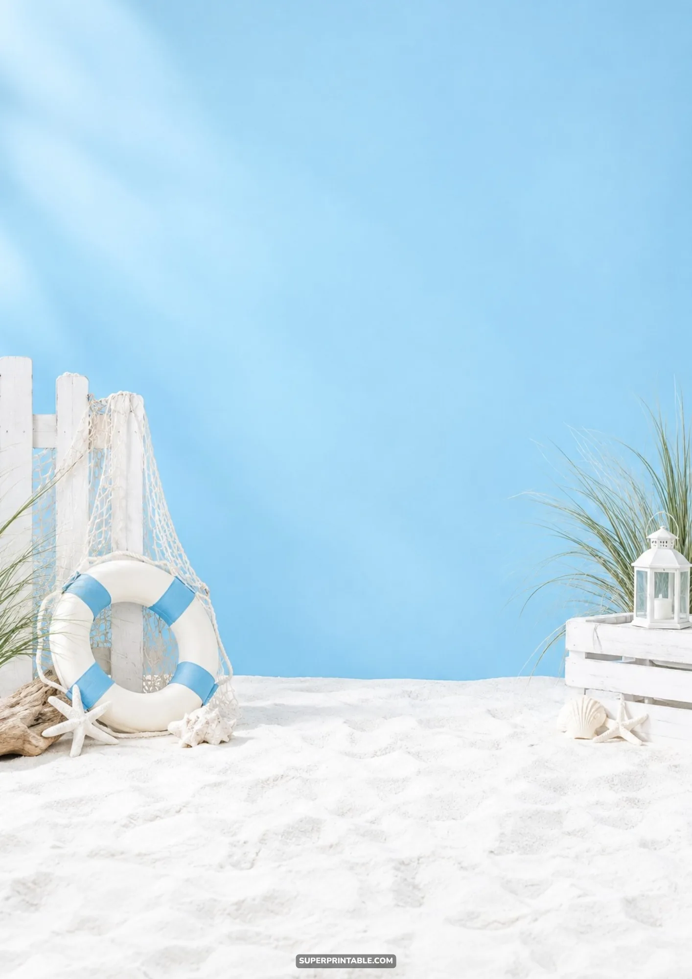 Studio beach setup with white sand, lifebuoy, picket fence, and lantern