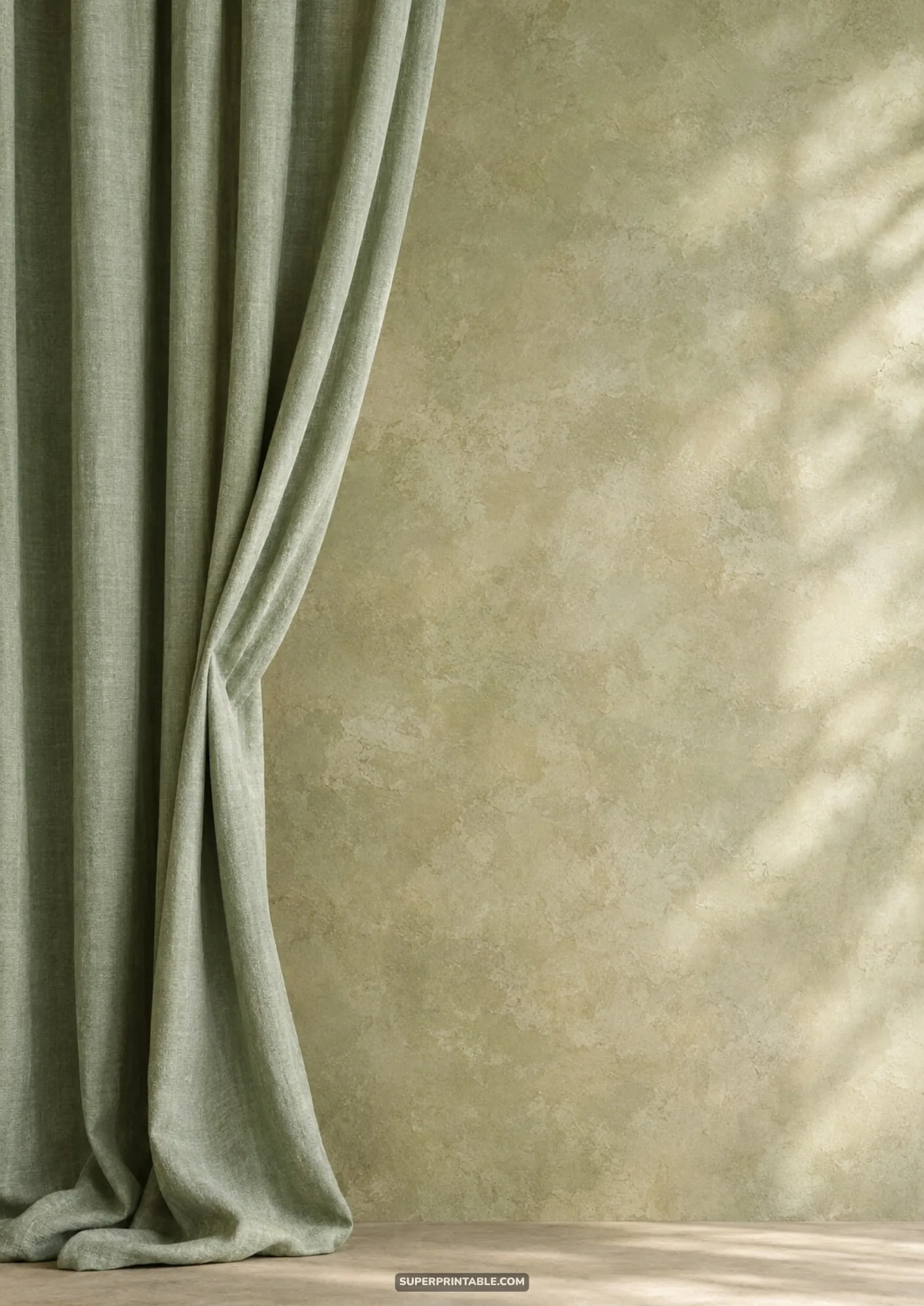 Sage green fabric drape framing the left side of an olive textured plaster stucco wall