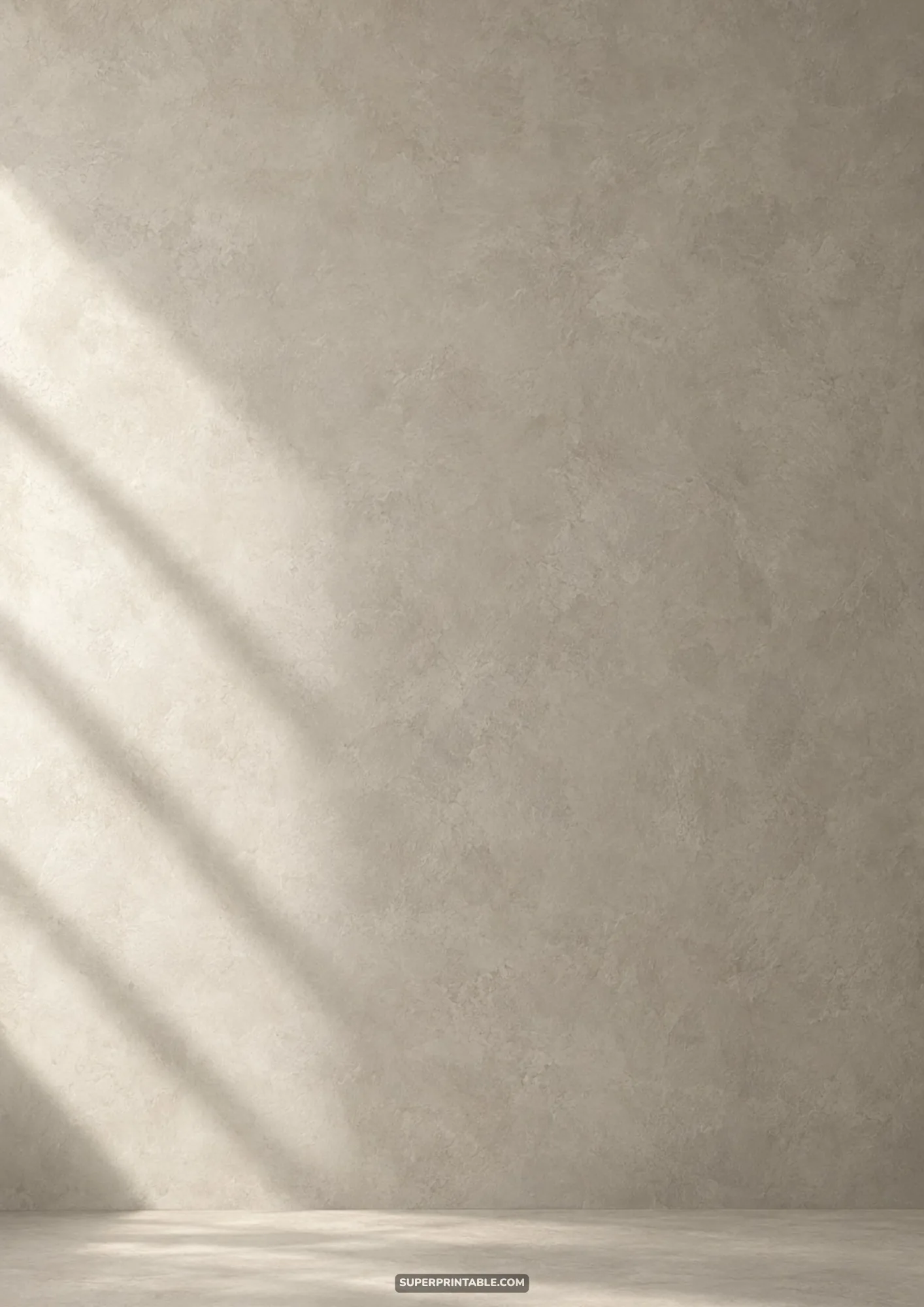 Pale greige concrete wall texture crossed by gentle diagonal morning sunlight and soft shadows