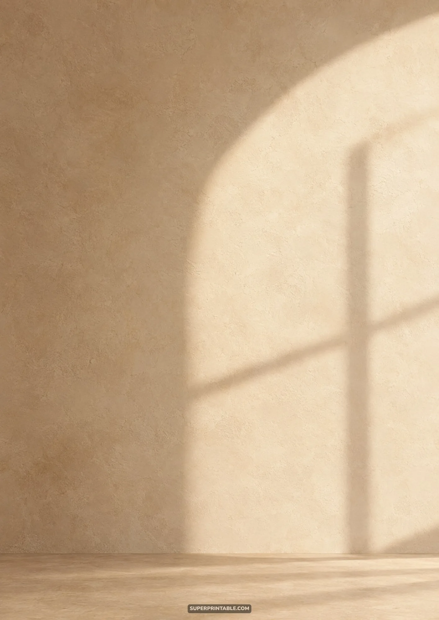 Warm beige studio wall with natural arched window frame shadow cast across textured plaster
