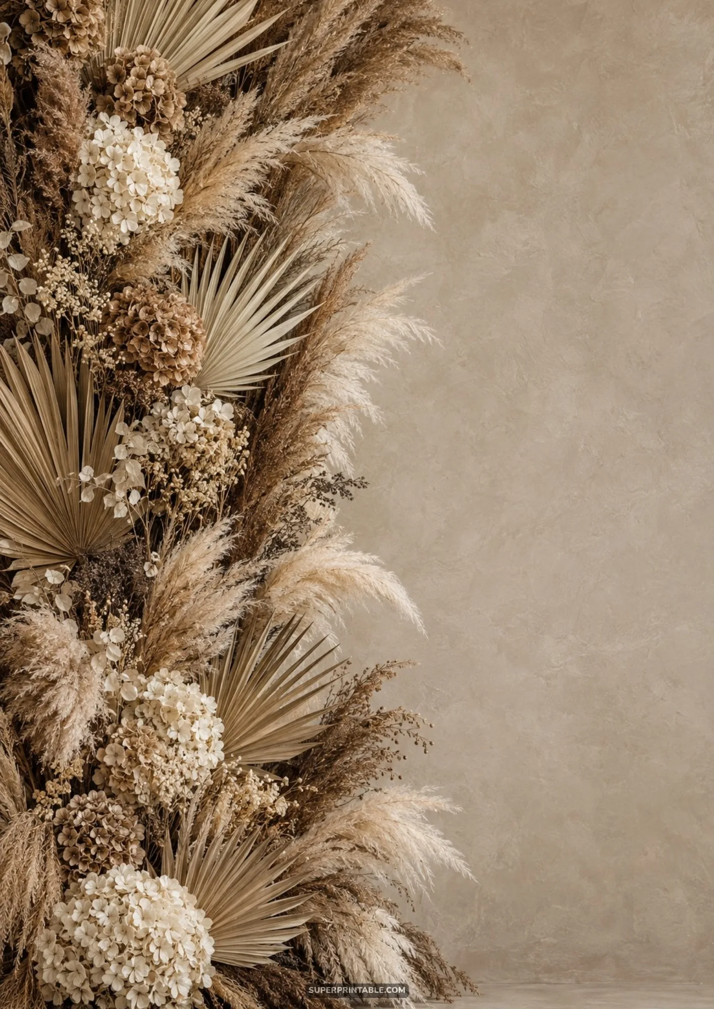 Vertical dried flower arch arrangement featuring white hydrangeas, palm fans, and fluffy pampas plumes.
