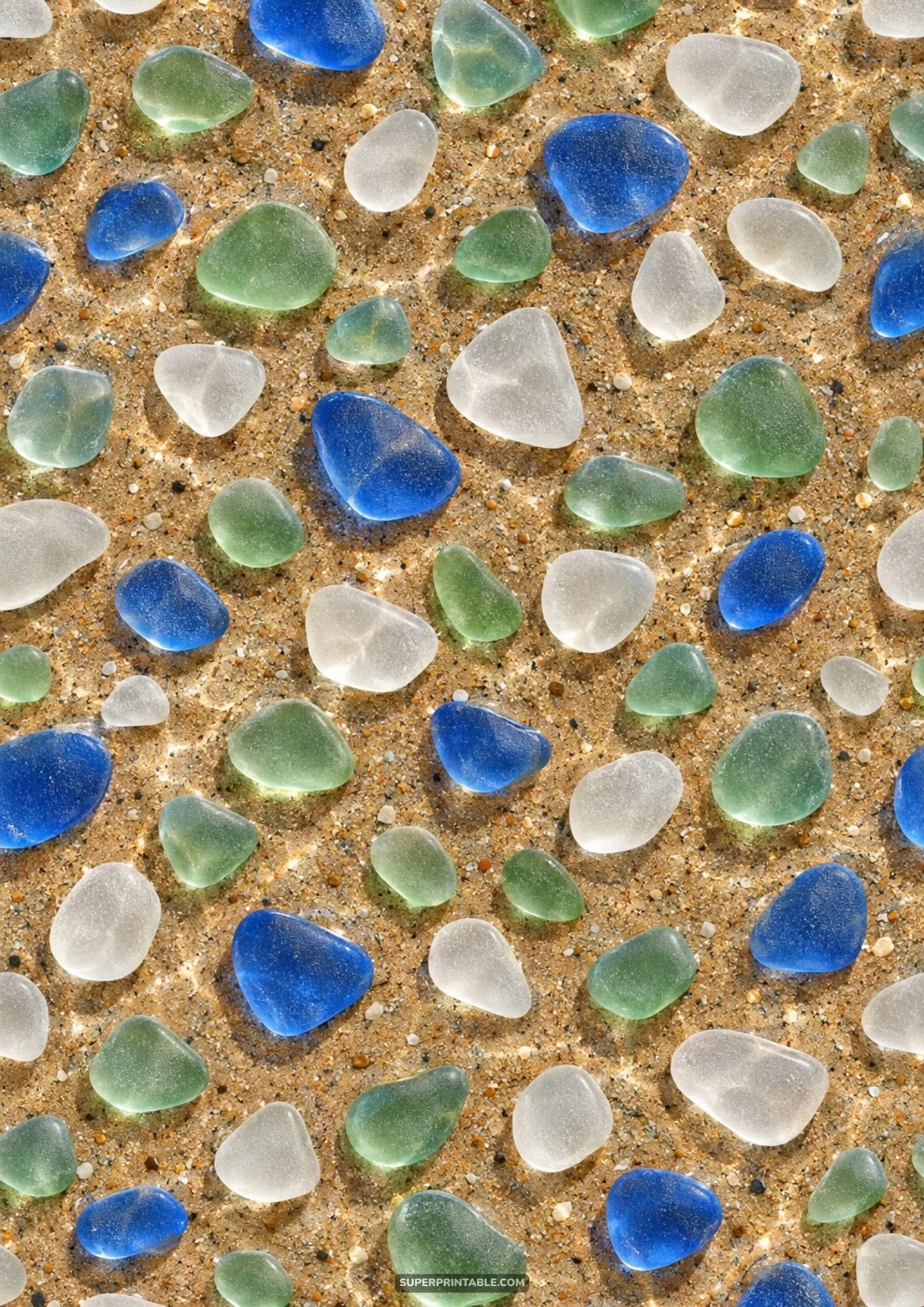 Cobalt blue, seafoam green, and frosted white tumbled sea glass stones on wet beach sand