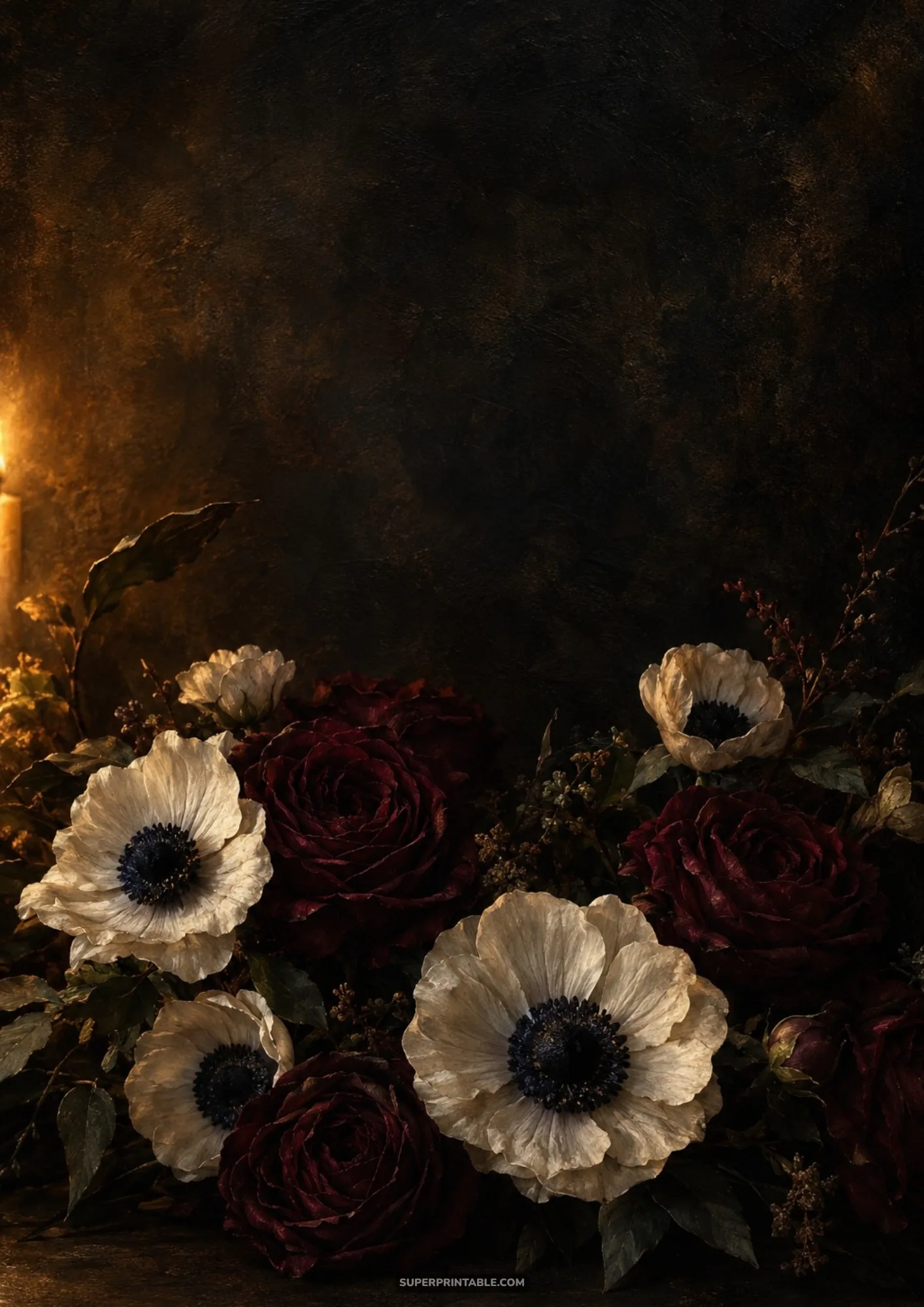 White anemones and deep red roses illuminated by soft golden candlelight on dark ground